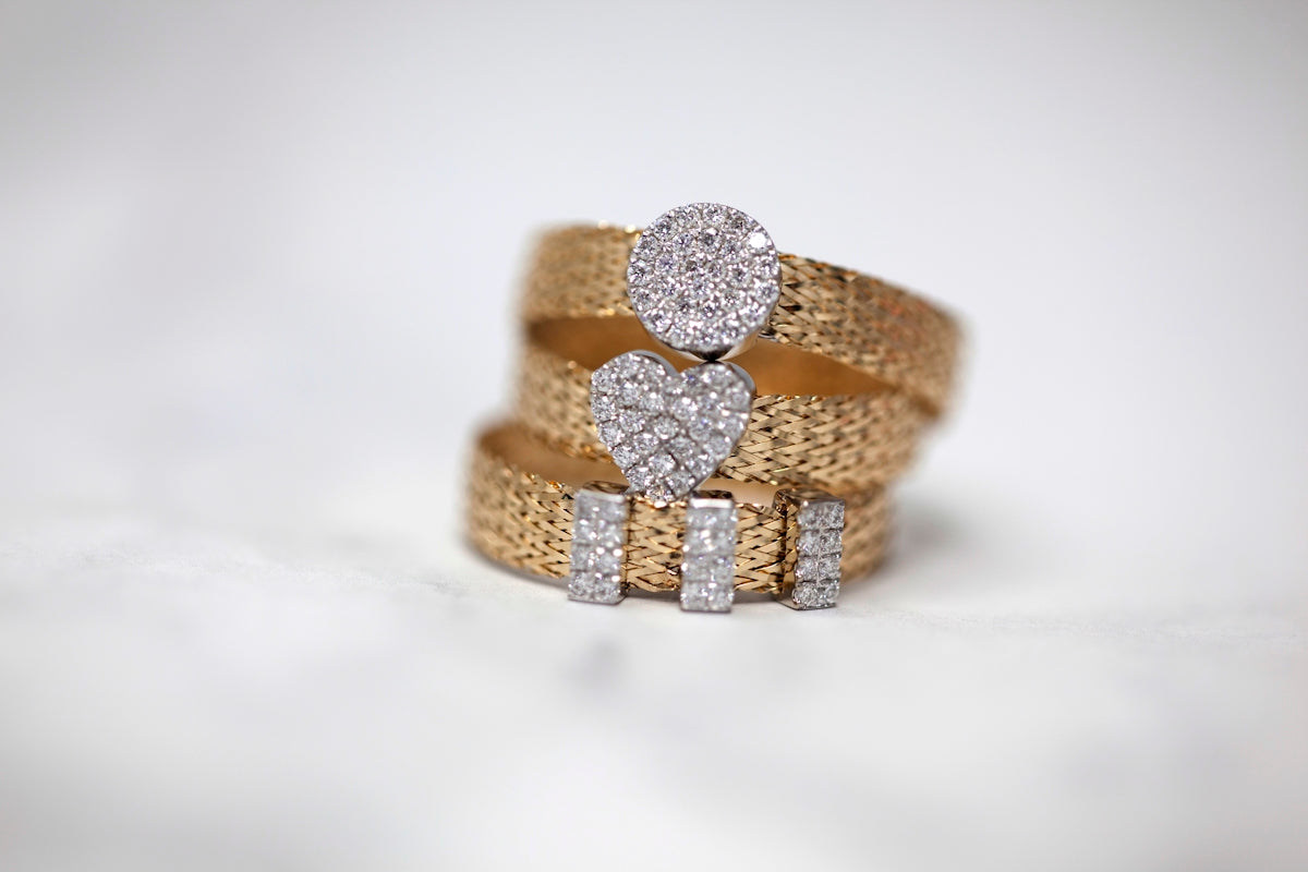 three gold-colored studded rings