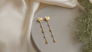 golden heart fall earring on marble